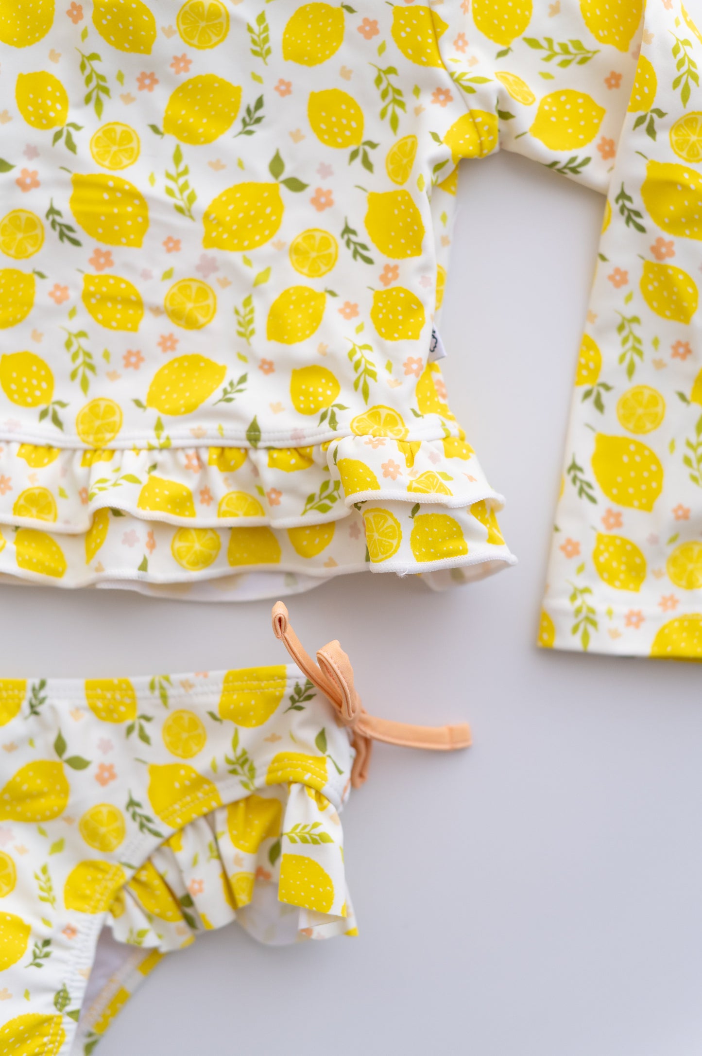 LEMON BLOSSOMS DREAM RASH GUARD RUFFLE TWO-PIECE SWIM SUIT
